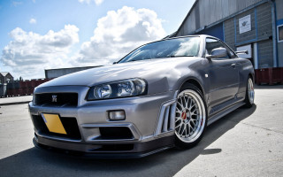 Silver car building sky clouds - a yellow stripe free wallpaper