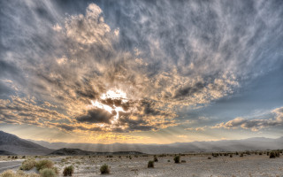 Cloudy desert mountains sunset city - the background and sun free wallpaper