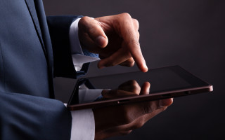 Man in suit holding tablet - technology free wallpaper