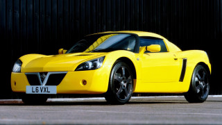 Yellow sports car black wall - a license plate free wallpaper