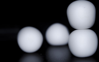 White balls black surface moon - diffuse free wallpaper