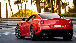 Red sports car driving palm - a parking meter free wallpaper