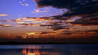 Sunset clouds reflection sailboat cityscape - colorful cloud free wallpaper
