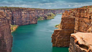 Large water rocky cliffs boat - a large body of water free wallpaper for desktop