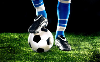 Soccer player blue white kicking - his foot free wallpaper