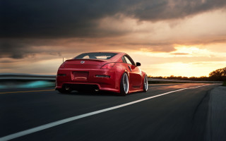 Red sports car driving sunset 2 - the sun behind free wallpaper