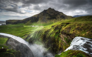 Waterfall lushgreen hillside cloudy sky - top of a mountain free wallpaper