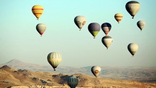 Hot air balloons mountains sky - over a mountain range in the sky free wallpaper