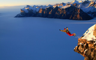 Man jumping cliff snowboard mountain 2 - free bird wallpaper