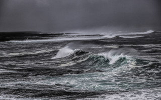 Stormy wave ocean horizon mountain - a dark sky in the background free wallpaper