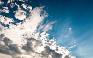 Plane clouds blue sky ocean - the background and a plane in the foreground free wallpaper