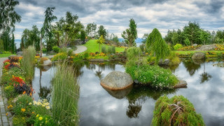 Pond park rock flowers landscape - a lush green park free wallpaper