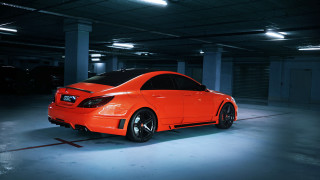Bright orange car parking garage - a black hood free wallpaper