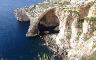 Cliff cave ocean blue water - a cave free wallpaper