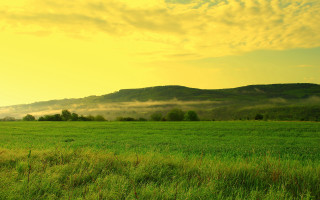 Mountain field yellow sky clouds - free landscape wallpaper