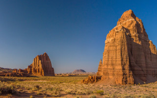 Desert rock formation blue sky - a few bush and bushes free wallpaper
