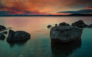 Sunset lake rocks clouds horizon - the water and a sky free wallpaper