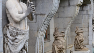 Statue man staff arches columns - a statue of a man holding free wallpaper