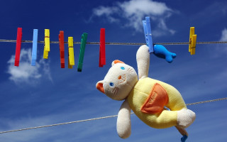 Stuffed animal clothesline blue sky - a clothes line free wallpaper