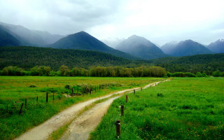 Dirt road mountains cloudy sky - a dirt road in a field free wallpaper for desktop