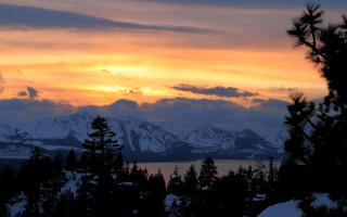Sunset mountain range trees snow - a sunset view of a mountain range free wallpaper for desktop