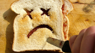 Person cutting bread face knife - ultra free wallpaper