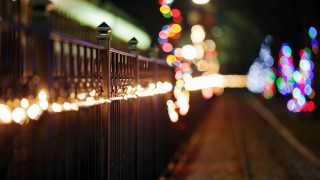 Fence lights train track night - a train track in the background free wallpaper