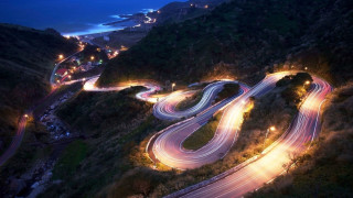 Mountain road lights night city - winding free wallpaper