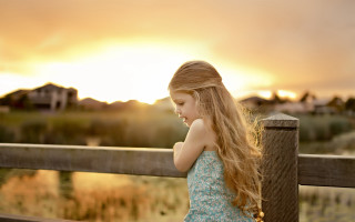 Young girl fence sunset beach - a wooden fence free wallpaper