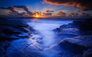 Sunset rocky beach long exposure - a sunset over a rocky beach free wallpaper