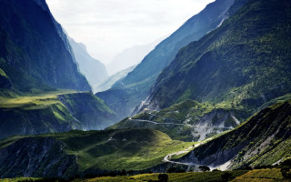 Mountain valley winding road nature - road in the middle of it free wallpaper