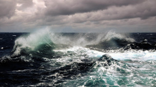 Stormy ocean wave boat clouds - a large wave free wallpaper