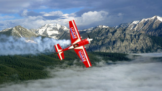Red white plane mountain range - over a mountain range free wallpaper