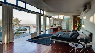 Ocean mountains view living room - a couch and a table free wallpaper