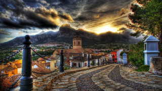 Cobblestone village clocktower mountain landscape - a village free wallpaper for desktop