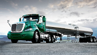 Green semi truck tanker detailed - a gravel road free wallpaper