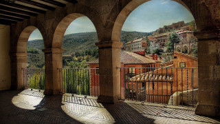 City arch fence mountain european - a painting of a city free wallpaper