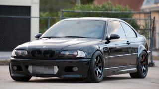 Black car chainlink fence building - a fenced in area free wallpaper