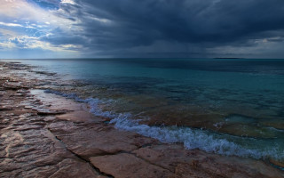 Beach water cloudy sky rocky - a few cloud above free wallpaper