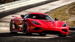 Red sports car race track - grass and bushes free wallpaper