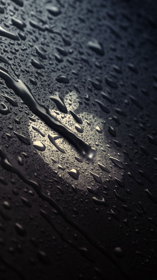 Rain drops closeup black background - surface free wallpaper