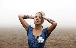 Tattooed woman field portrait blonde - her arm and shoulder free wallpaper