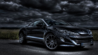 Black sports car cloudy parking - a parking lot under a cloudy sky free wallpaper