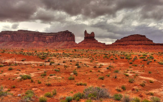 Desert rock formation cloudy sky - a large rock formation in the background free wallpaper