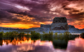 Sunset lake rock formation foreground - a few green plant free wallpaper