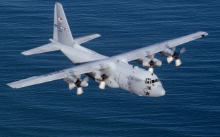 Large airplane over ocean landing - over the ocean water free wallpaper