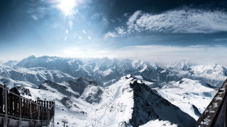 Mountain range snowy horizon sun - a bright sun free wallpaper
