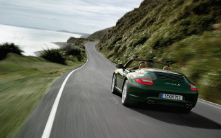 Green sports car cliffside ocean - a green sports car free wallpaper
