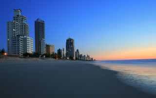 Beach city dusk sand buildings - a few person free wallpaper for desktop