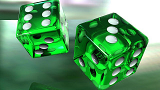 Two green dices white dots - a blurry background behind them free wallpaper
